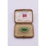 A pearl and enamel memento mori brooch, unmarked, 3.5cm wide, in fitted case, 8.2g total weight.
