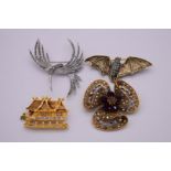 Four large contemporary costume brooches, to include a bat example; and a marcasite crane etc.