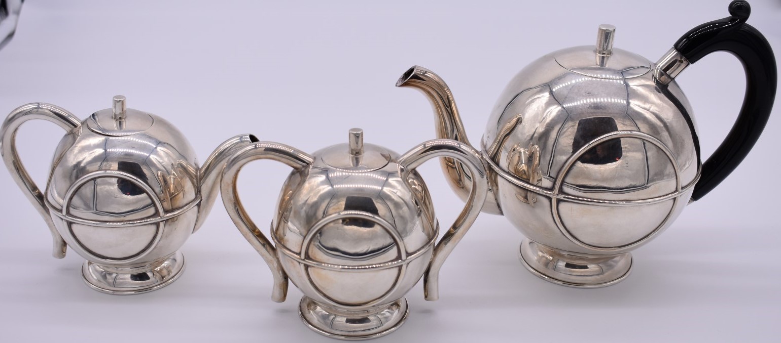 A Scandinavian Art Deco style three piece teaset, stamped .925, 977g all in.