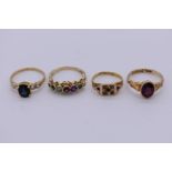 A pearl and garnet gold ring, stamped 15ct; together with two gem set gold rings, stamped 9ct,