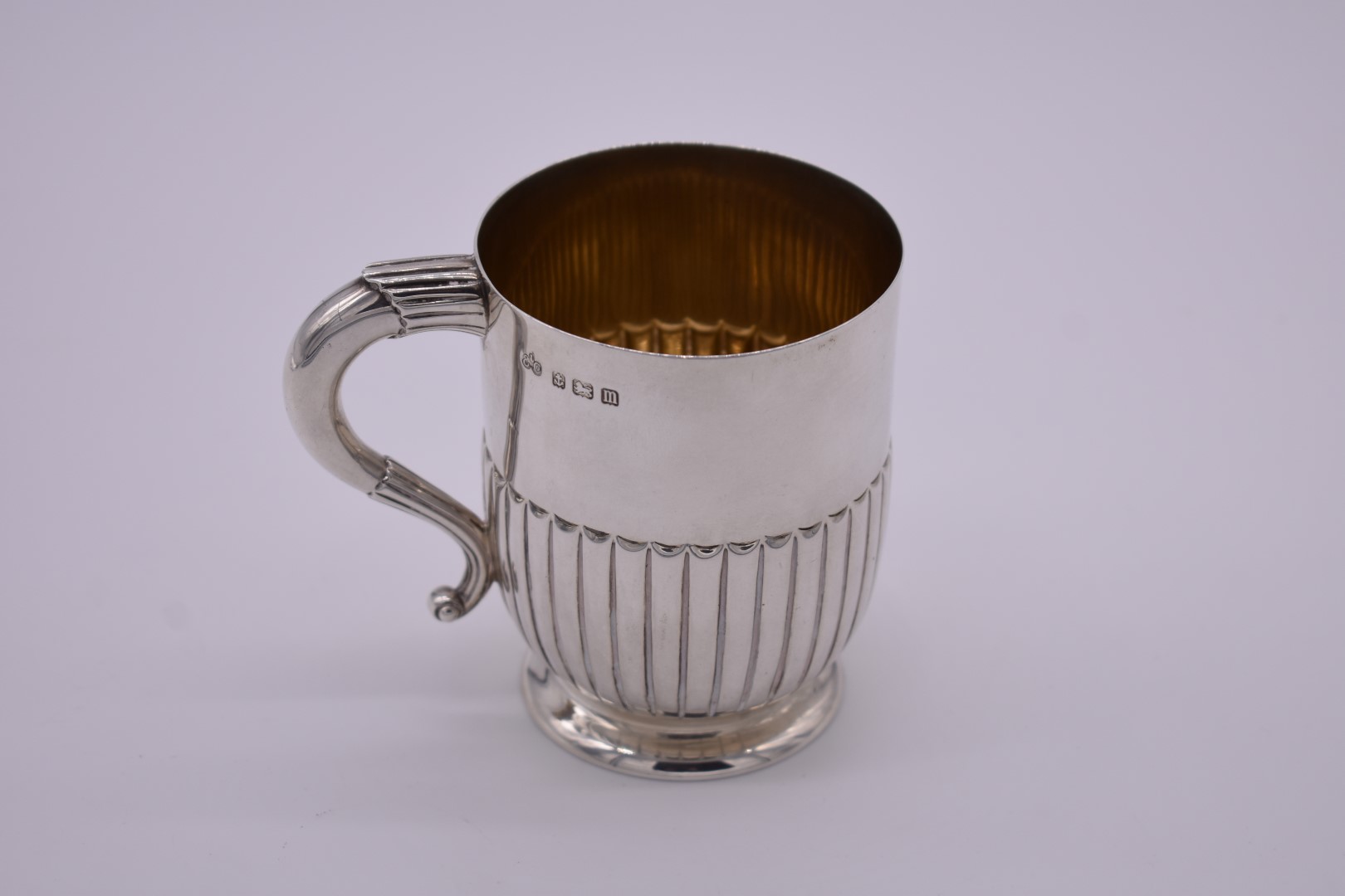 A silver Christening mug, by Elkington & Co Ltd, Birmingham 1911, gilt lined, 9cm high, 199g.