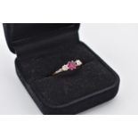 A ruby and illusion set diamond gold ring, stamped 18ct & plat, 2.2g total weight.