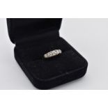 A five stone diamond gold ring, stamped 18ct, 2.7g total weight.