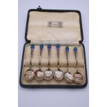 A cased set of six silver and enamel coffee spoons, by Liberty & Co, Birmingham 1934, 54g all in.