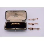 Two gem set gold bar brooches, stamped 9ct, 4.2g total weight; together with two similar unmarked