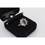 A large blue topaz gold cocktail ring, stamped 750, 7.1g total weight.