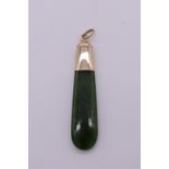 A polished jadeite pendant, having unmarked mount, 11.3g total weight.