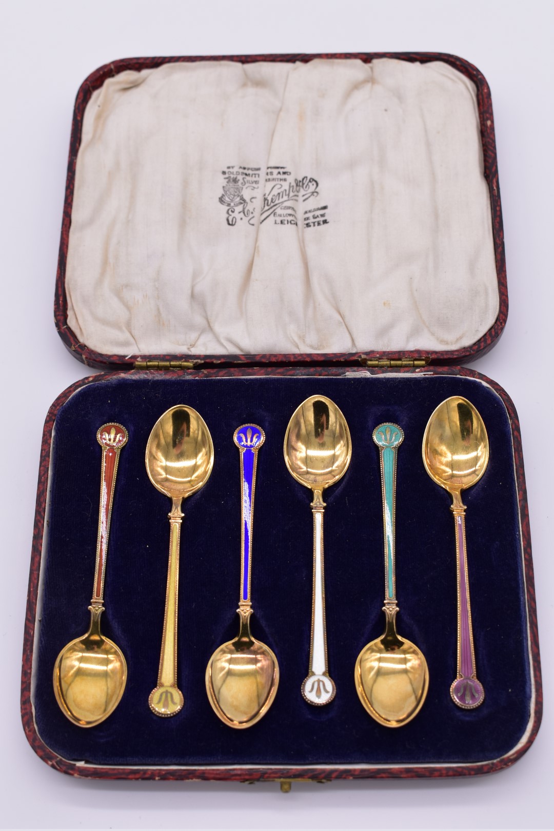 A cased set of six sterling gilt and coloured enamel coffee spoons, by David Anderson, Oslo 1925 -