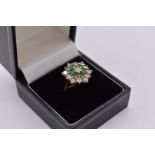 An emerald and diamond cluster gold ring, hallmarked 18ct, 6.5g total weight.