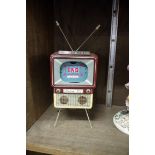 A rare 1950s Haji 'Made in Japan' tin plate novelty musical 'Color TV Bank', 23.5cm high.