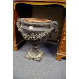 An old black painted terracotta twin handled pedestal urn, in the Robert Adam style, 47cm