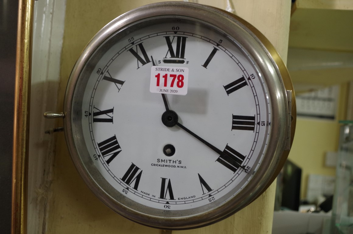 A Smith's brass bulkhead timepiece, with enamel dial, 23cm diameter.