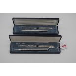 Two cased silver pen and paper knife sets. (2)