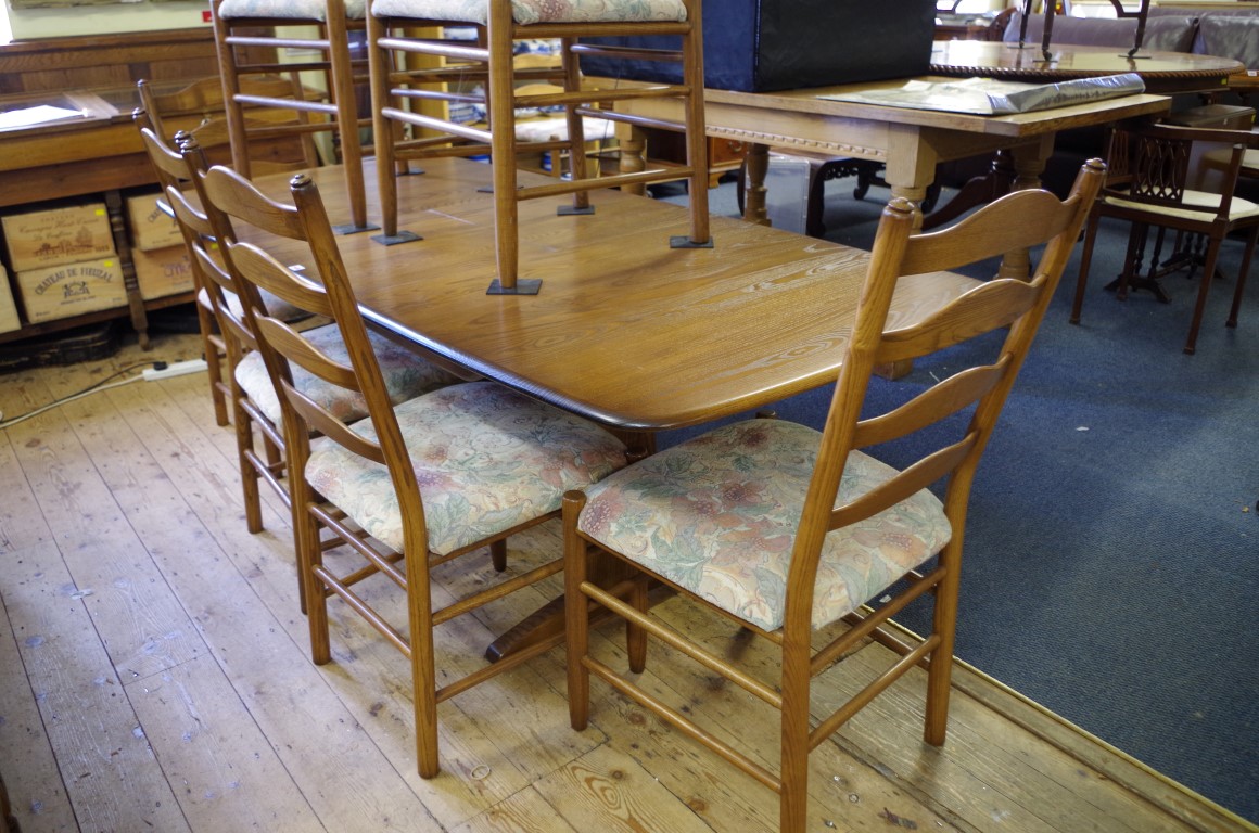 An Ercol 'Golden Dawn' dining table and chairs, comprising a drawleaf table, 203cm extended; and - Image 2 of 2