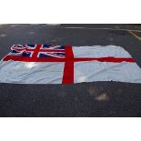 A large white ensign flag, with broad arrow stamp, 180 x 370cm; together with an Australian flag, 86