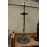 A large antique Continental brass candlestick, 70cm high.