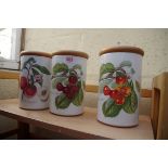 Three Portmeirion 'Pomona' storage jars and wooden covers, 21.5cm high.