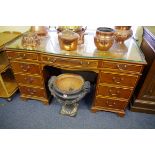 An early 20th century mahogany, line inlaid and crossbanded pedestal desk, with brass three