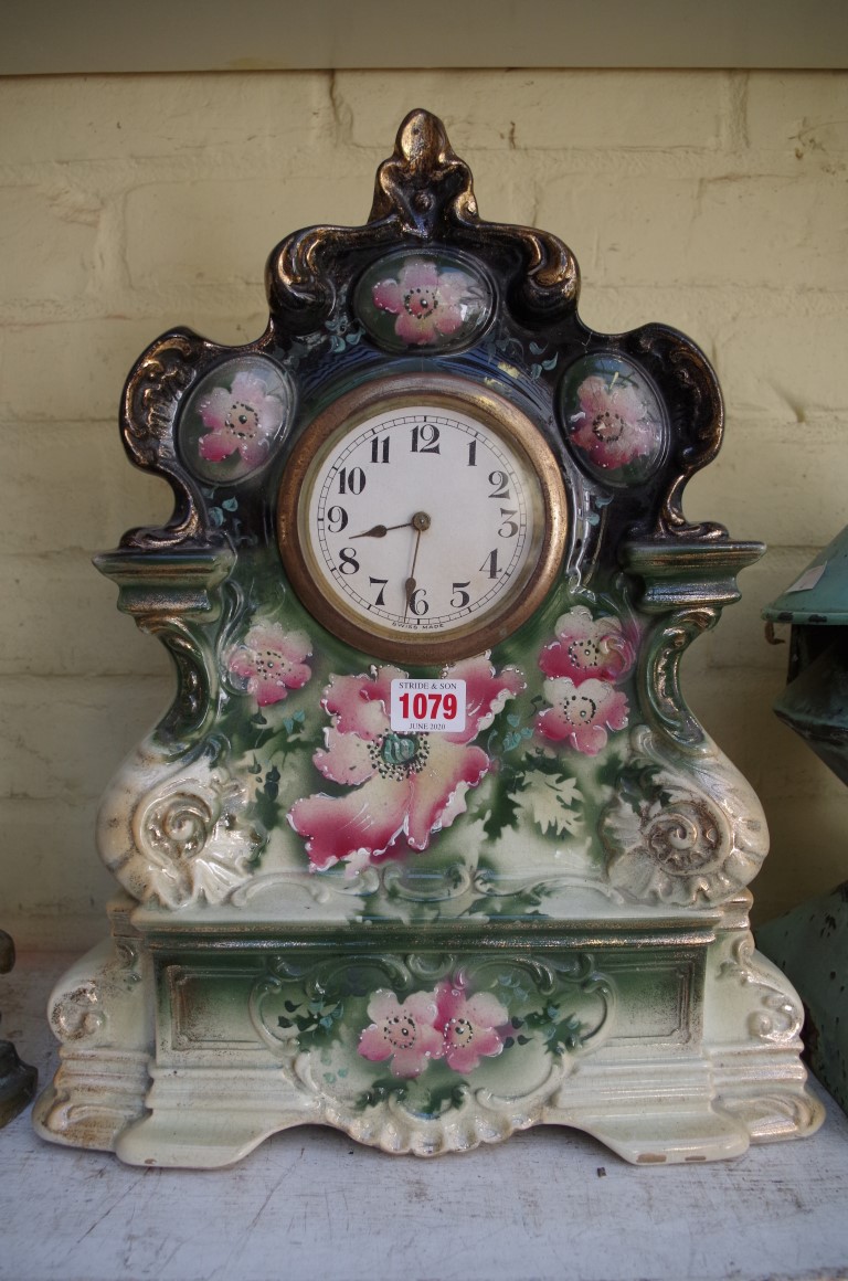 An old pottery mantel timepiece, 42cm high.