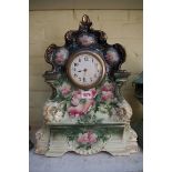An old pottery mantel timepiece, 42cm high.