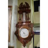 An antique French carved beech aneroid wheel barometer, 69cm high.