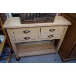 A modern pale oak two drawer side table, 99cm wide.