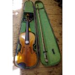 An antique Continental violin, labelled 'Joseph Guarnerius...', with 14in two piece back, with bow