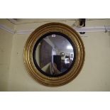 An antique gilt framed circular convex wall mirror, 54cm diameter.