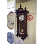 A late 19th century walnut and ebonized Vienna style wall clock, with enamel dial and spring