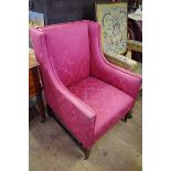 A 19th century mahogany and red damask wing armchair.