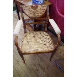 A 19th century stained, painted and caned open arm elbow chair; together with a Victorian photograph