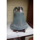 A antique patinated bronze bell, 23cm high.