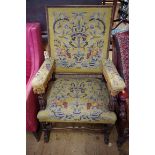 An antique 17th century style, carved walnut, beech and tapestry upholstered open arm chair.