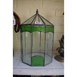 A green stained and clear glass leaded terrarium, 33cm high.