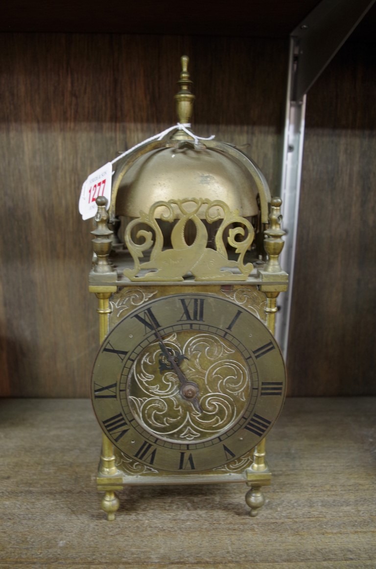 An old reproduction brass lantern style clock, 30cm high.