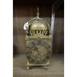 An old reproduction brass lantern style clock, 30cm high.