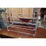An antique white painted wrought iron rack, possibly for wine, 57cm wide.
