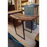 An oak and steel stool, by Garth Bowden, 59.5cm wide.