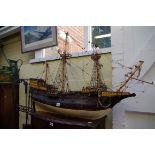 An old painted wood model galleon, the hull 93cm long.