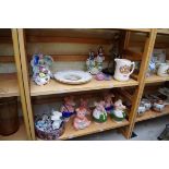A mixed group of pottery and porcelain, to include Nat West piggy banks. (two shelves)