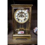 An Ansonia brass four glass mantel clock, with exposed escapement and mercury pendulum, 27.5cm high,