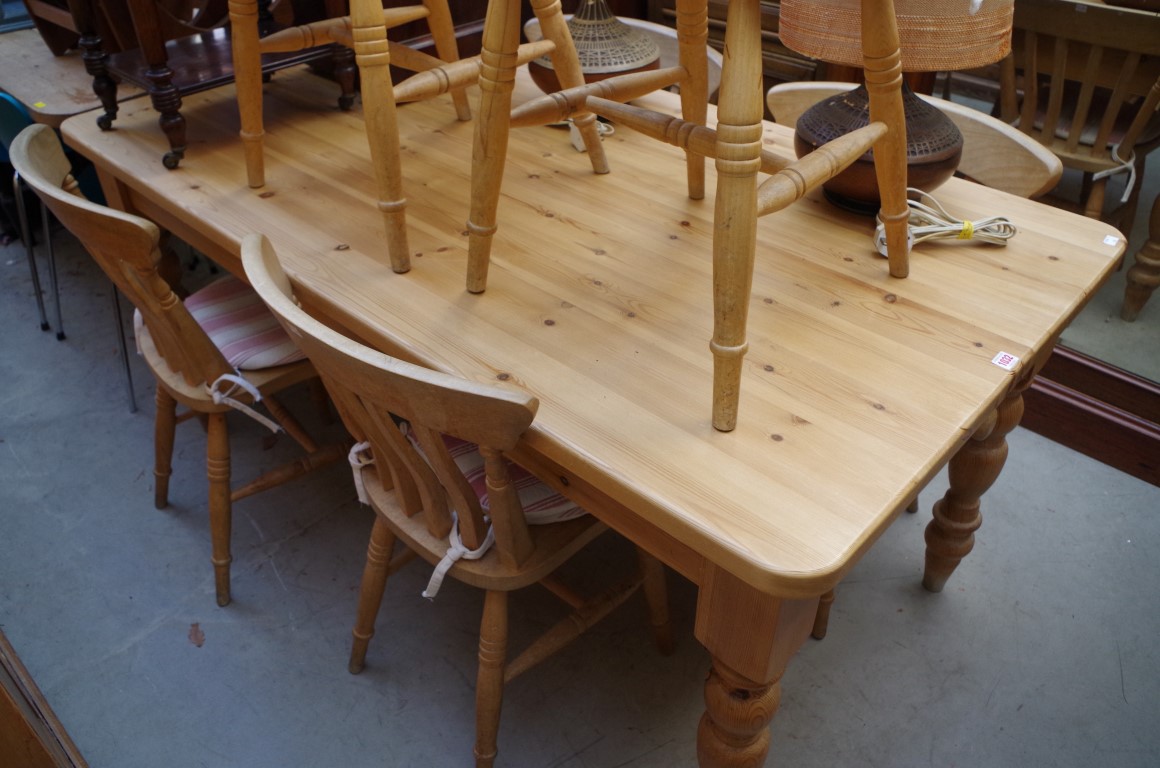 A pine kitchen table and six beechwood chairs, the table with opposing lateral frieze drawers, 167cm