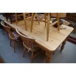 A pine kitchen table and six beechwood chairs, the table with opposing lateral frieze drawers, 167cm