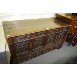 An old carved oak mule chest, 136cm wide.
