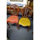 Two Victorian carved walnut dining chairs.