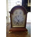 An early 20th century mahogany musical mantel clock, with arched silvered dial, striking on five