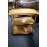 A vintage Ercol 'Blonde' three tier trolley, 70cm wide.