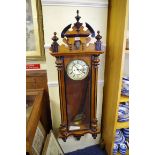 A Vienna style walnut and ebonized wall clock, the dial with subsidiary seconds, 127cm high, with