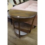 A nest of three Ercol 'Golden Dawn' tables, largest 61cm wide; together with a matching demi-lune