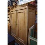 A late 19th century Continental pine double wardrobe, with a pair of apron drawers, 142cm wide.